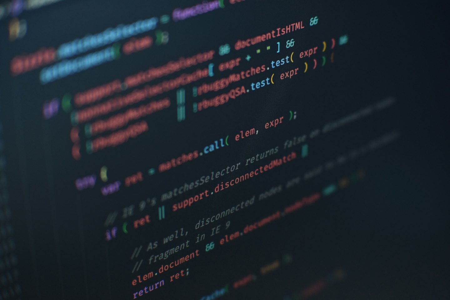 Colorful programming code displayed on a dark computer screen.